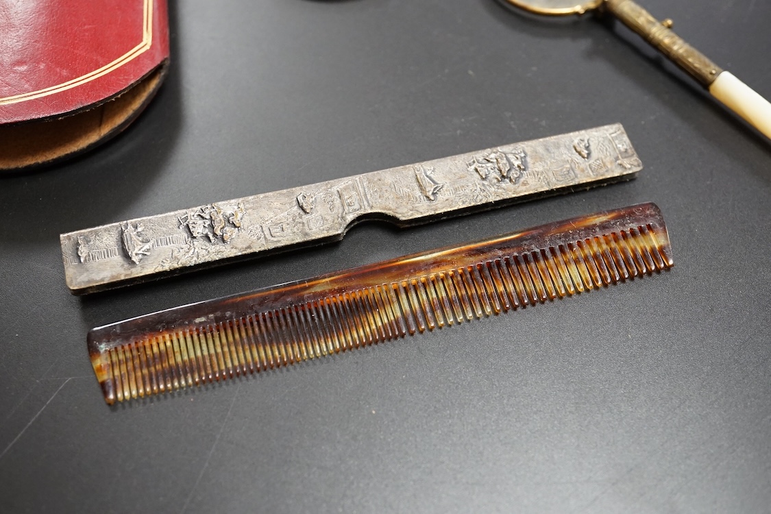 A pair of mother of pearl handled gilt metal lorgnettes in a leather case and a comb housed in an antimony case, largest 16cm in length